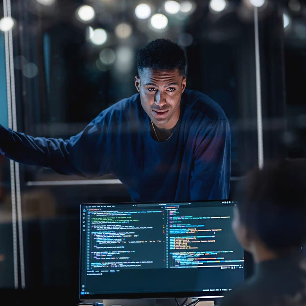 A developer working at a large monitor